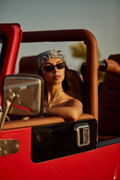 istock A beautiful woman explorer driving a convertible jeep. 2173720590