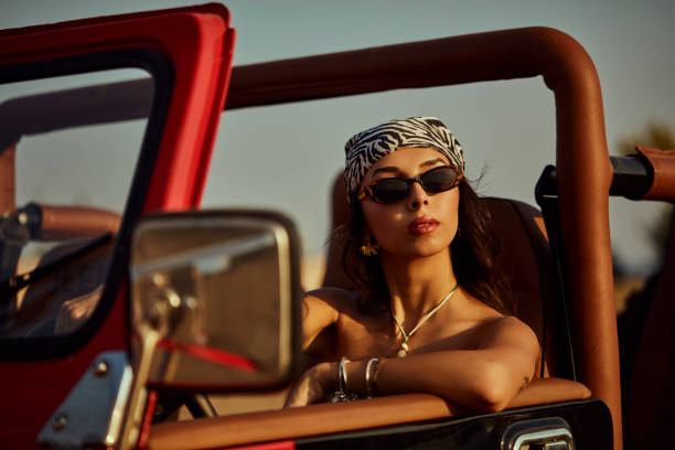 istock A beautiful woman explorer driving a convertible jeep. 2173720623