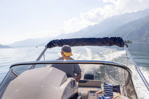 istock Man Driving a Speedboat on a Lake with Mountain Views 2173722851