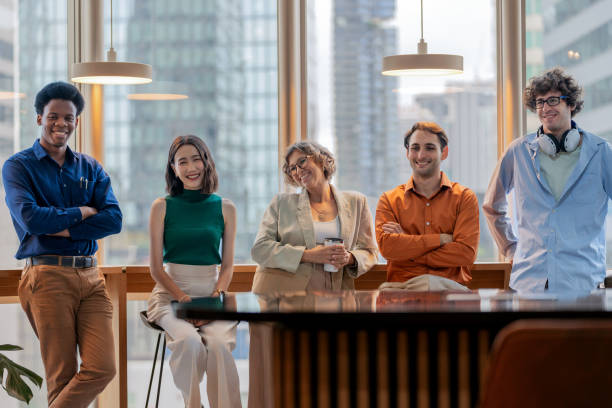istock A diverse group of multi-ethnic office workers stand confidently with their arms crossed, smiling in a modern office setting. The team exudes professionalism and leadership, embodying teamwork, resilience, and trust in a collaborative business environment 2173725903