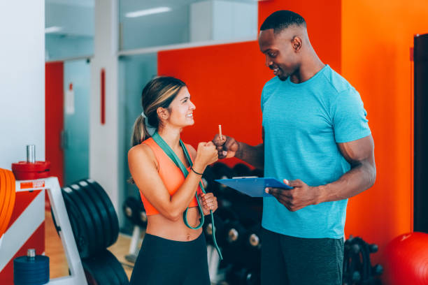 istock Sports training in the gym with personal trainer 2173731069