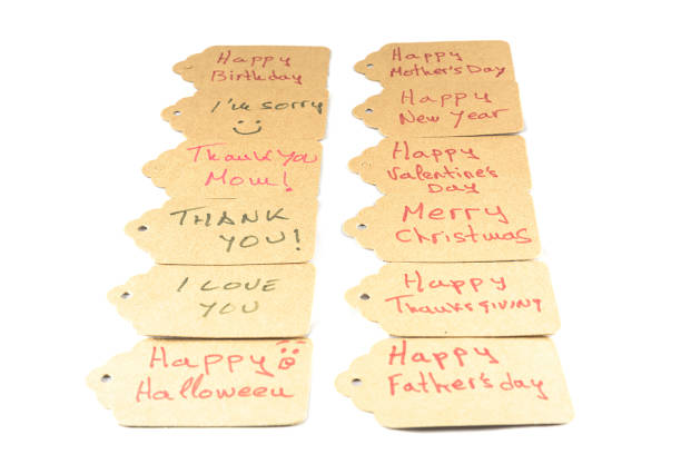 Blank brown paper price tag or label on golden textile, fabric. Space for text. Gift tag, sale tag.