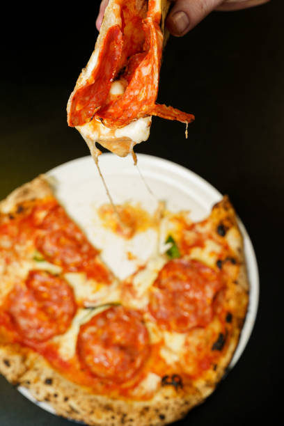 istock Taking a slice of salami pizza with melted cheese 2173734206