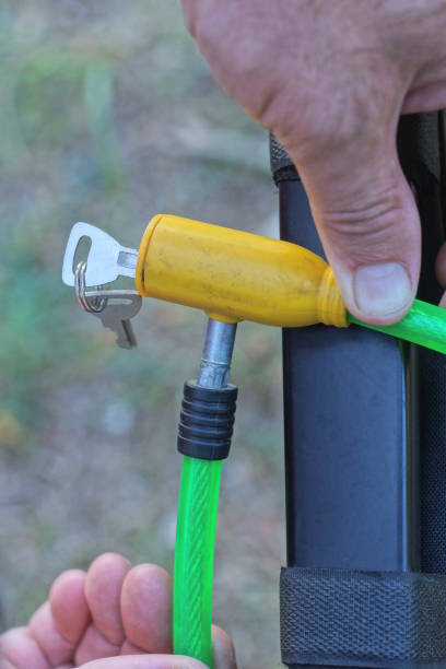 istock man hand opening small key green yellow bicycle lock 2173744858