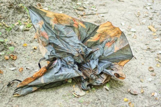 istock one old broken colored umbrella lies on the gray ground 2173745078