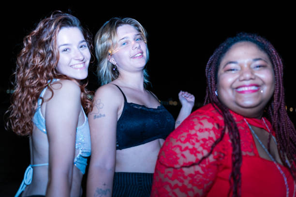 istock Three friends smiling and having fun at night 2173749526