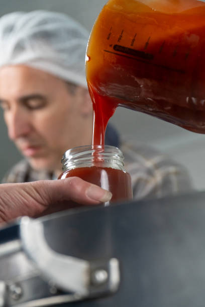 istock Pouring Homemade Rosehip Jam into a Jar 2173750164