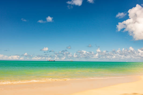 Caribbean beach with white sand, deep blue sky and turquoise water