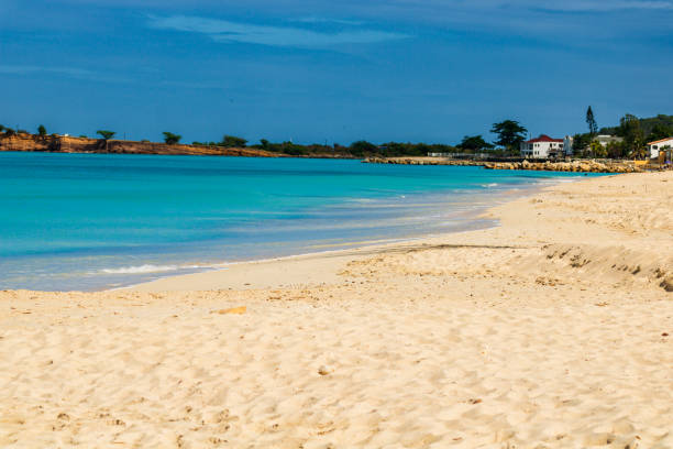 Caribbean beach with white sand, deep blue sky and turquoise water