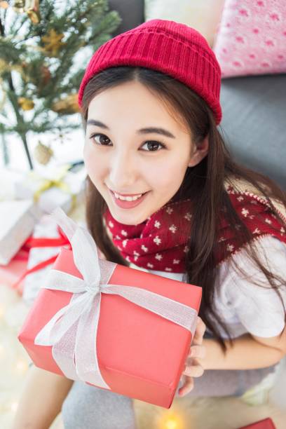 Asian woman holding a Christmas present