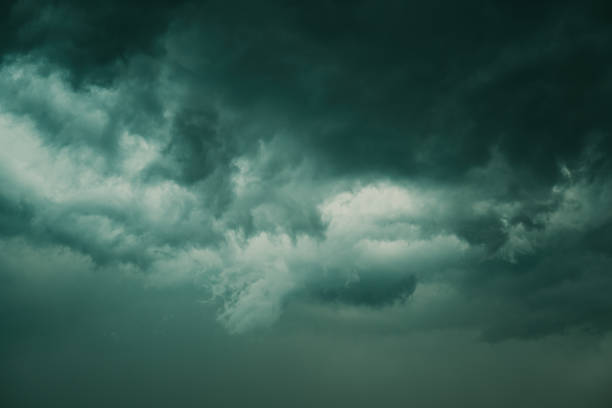 Dark supercell stormy clouds in summer, low angle view