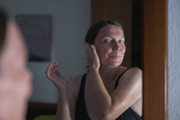 istock Woman applying sun lotion on face at home 2173766346