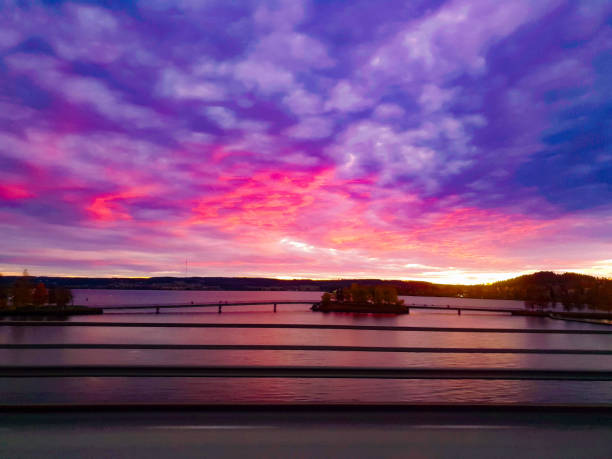 Fluffy clouds at sunrise with lake reflections