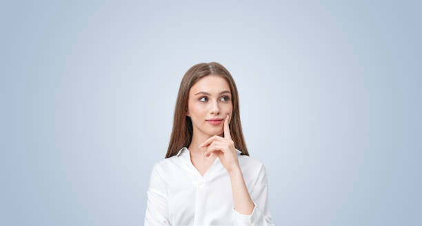 istock Thoughtful woman with a smile, touching her face, looking sidewa 2173775845