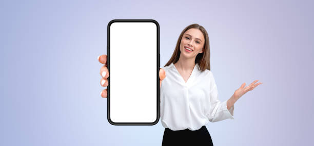 istock Woman holding a phone with a blank screen, presenting a display 2173776908