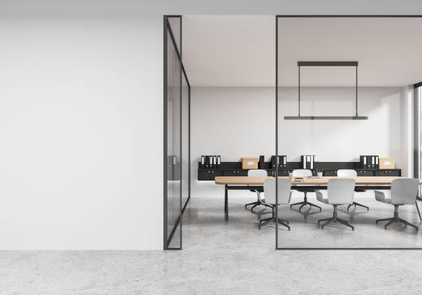 istock Stylish meeting interior with table and chairs, drawer and mockup wall 2173777105
