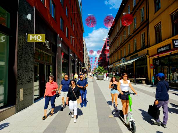 Drottninggatan (Queen Street) in Stockholm, Sweden, is a major pedestrian street. It stretches north from the bridge Riksbron at Norrström. The image shows the street with several pedestrians, captured during summer season.