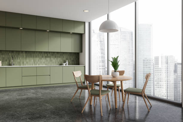 istock Stylish home kitchen interior with dining table, cabinet and panoramic window 2173778934
