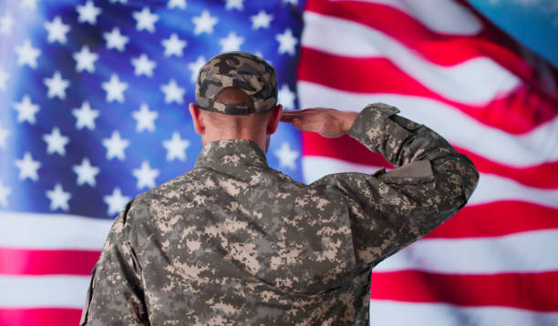 istock Military US Soldier Saluting Flag 2173783082