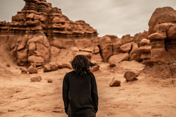 From Behind Person Walking Through Desert Rocks Utah