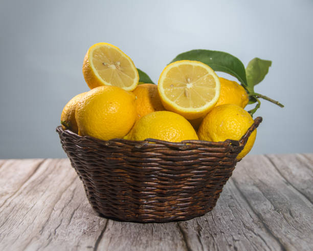 istock lemons in a basket, with one cut showing its interior 2173791795