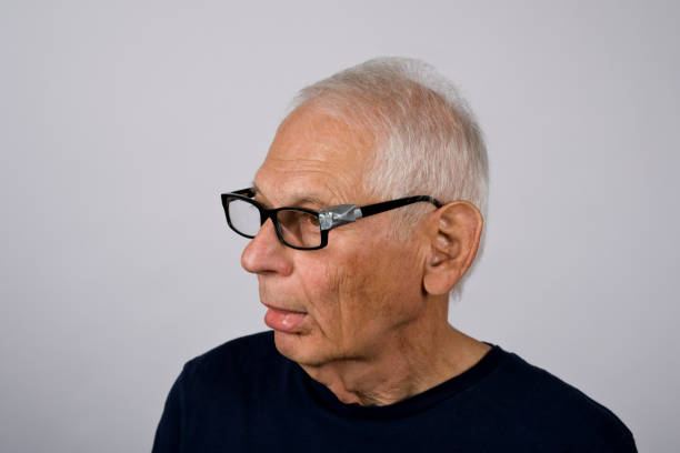 istock Senior man peculiar look, tape on glasses 2173794555