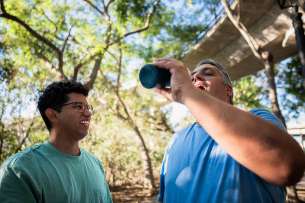 istock Gay couple taking break during outdoor training and drinking water 2173802186