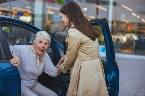 istock Senior Woman Receiving Help from Friend to Exit Car 2173808834