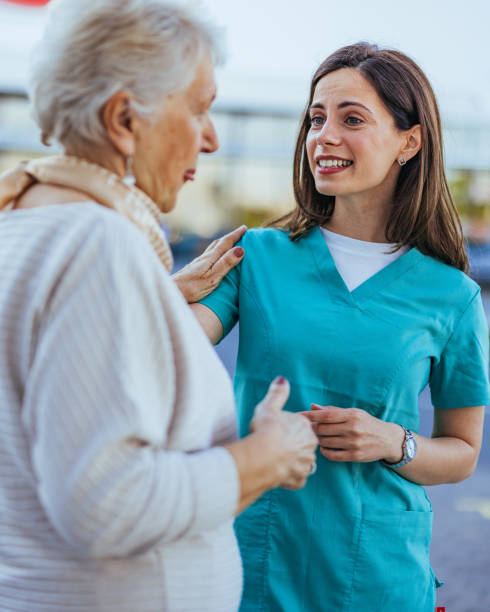 istock Nurse Comforting Elderly Woman Outdoors with a Smile 2173809147