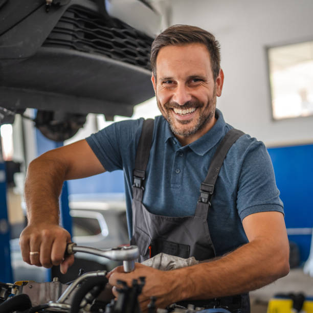 istock Portrait of cheerful car mechanic work on car engine in workshop 2173809604