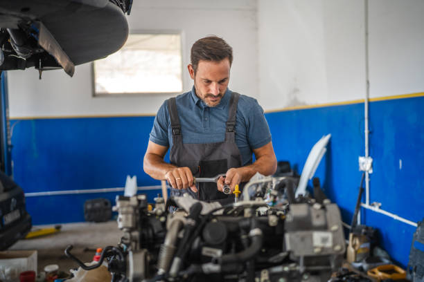 istock Car mechanic work on car engine with wrench in a garage setting 2173809605