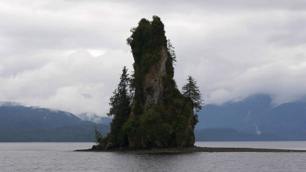 istock Rock Formation on an Isle in Front of Misty Mountains 2173811507