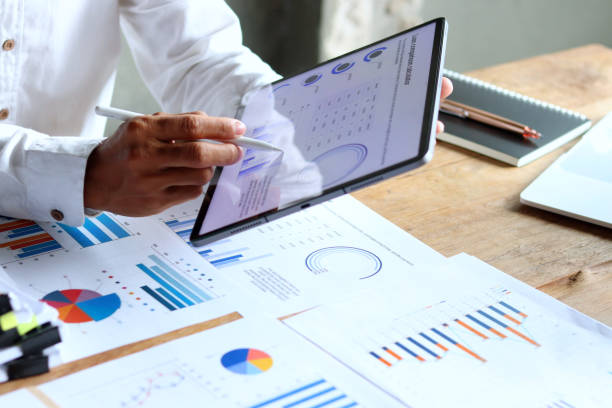 istock A 29-year-old businessman working hard to analyze the company's expense documents. 2173819289