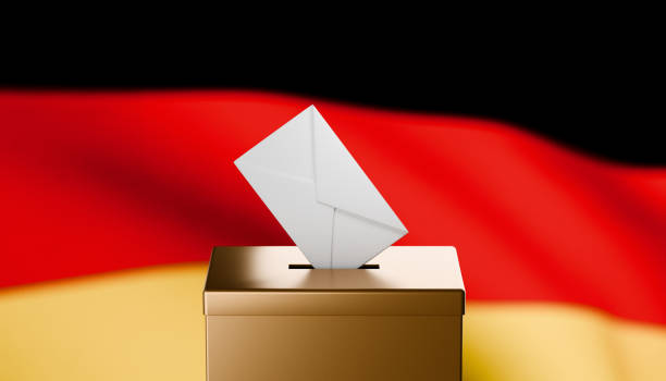 istock Envelope entering gold ballot box with a German flag in the background 2173827907