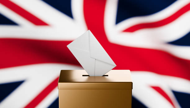 istock Envelope entering gold ballot box with a British flag in the background 2173827940