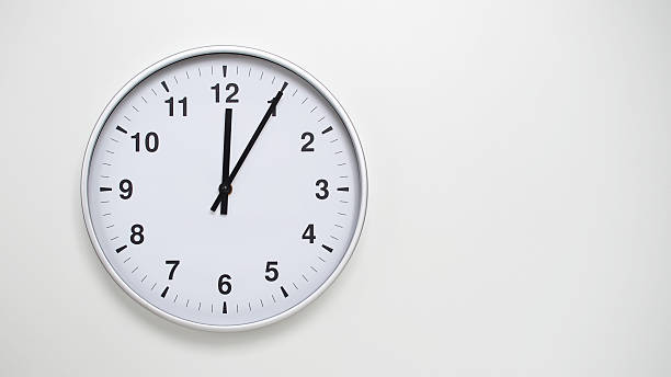 istock Minimalist White Clock with Silver Frame Striking  on White Background  Perfect for Time Management and Corporate Campaigns 2173832907