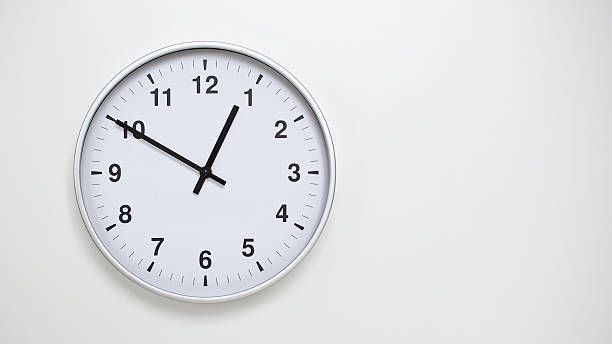 istock Minimalist White Clock with Silver Frame Striking  on White Background  Perfect for Time Management and Corporate Campaigns 2173832943