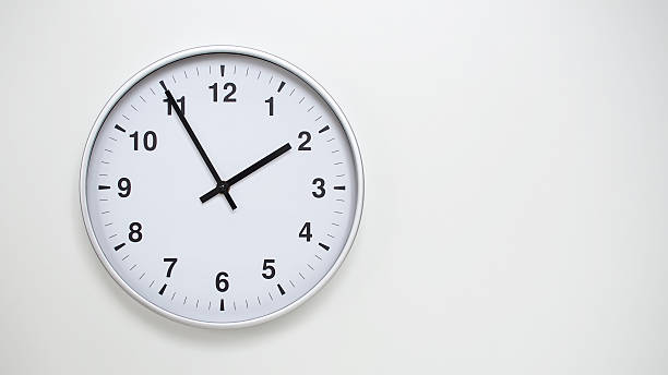 istock Minimalist White Clock with Silver Frame Striking  on White Background  Perfect for Time Management and Corporate Campaigns 2173832985