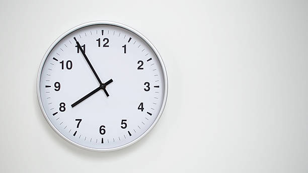 istock Minimalist White Clock with Silver Frame Striking 19.55/07.55 on White Background  Perfect for Time Management and Corporate Campaigns 2173833576