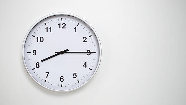 istock Minimalist White Clock with Silver Frame Striking 20.15/08.15 on White Background  Perfect for Time Management and Corporate Campaigns 2173833580