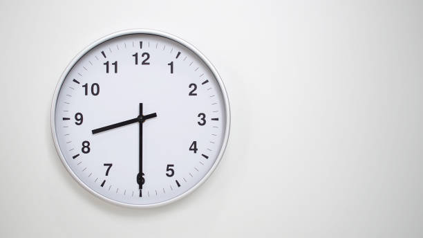istock Minimalist White Clock with Silver Frame Striking 20.30/08.30 on White Background  Perfect for Time Management and Corporate Campaigns 2173833600