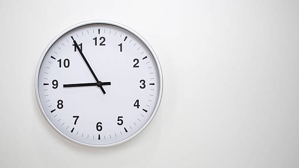 Minimalist White Clock with Silver Frame Striking 20.55/08.55 on White Background  Perfect for Time Management and Corporate Campaigns