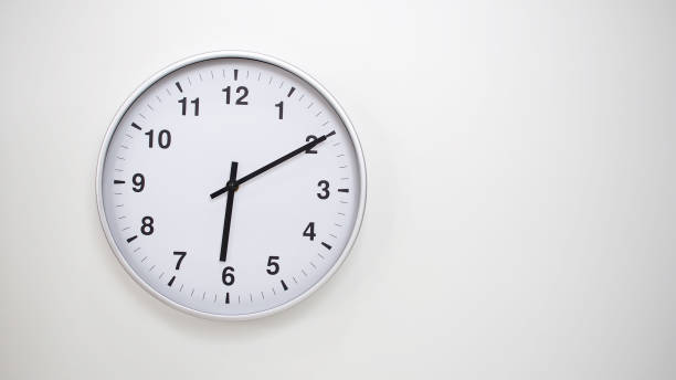 istock Minimalist White Clock with Silver Frame Striking 18.10/06.10 on White Background  Perfect for Time Management and Corporate Campaigns 2173833913