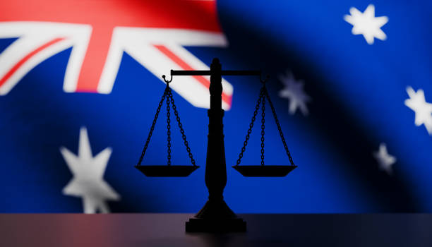 istock Justice scale in silhouette in front of an Australian flag 2173838892