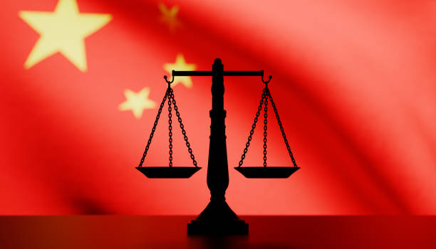 istock Justice scale in silhouette in front of a Chinese flag 2173838894