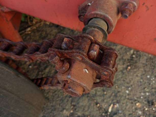 istock A thick machine chain is stretched on a sprocket to transmit torque in agricultural machinery. Thick metal iron rusty old chain on sprocket. 2173845238