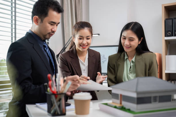 istock Business Team Discussing Real Estate Project in Modern Office with Architectural Model and Documents 2173849367