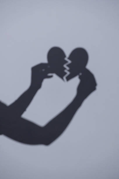 istock Shadow of hands that hold a broken heart 2173856156