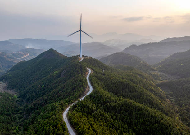 istock Wind power generation next to the forest mountaintop highway 2173861969