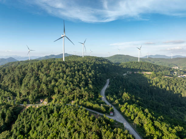istock Wind power generation next to the forest mountaintop highway 2173861976
